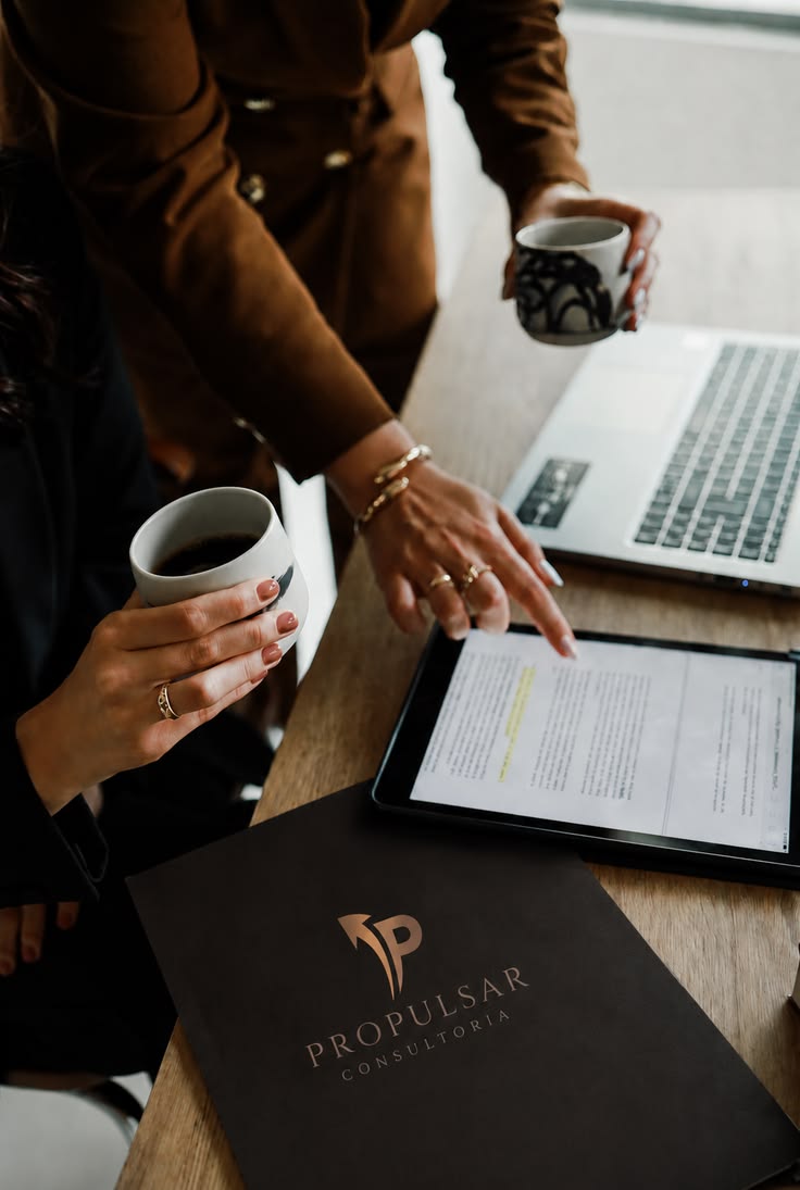 Advisers reviewing a document together over coffee