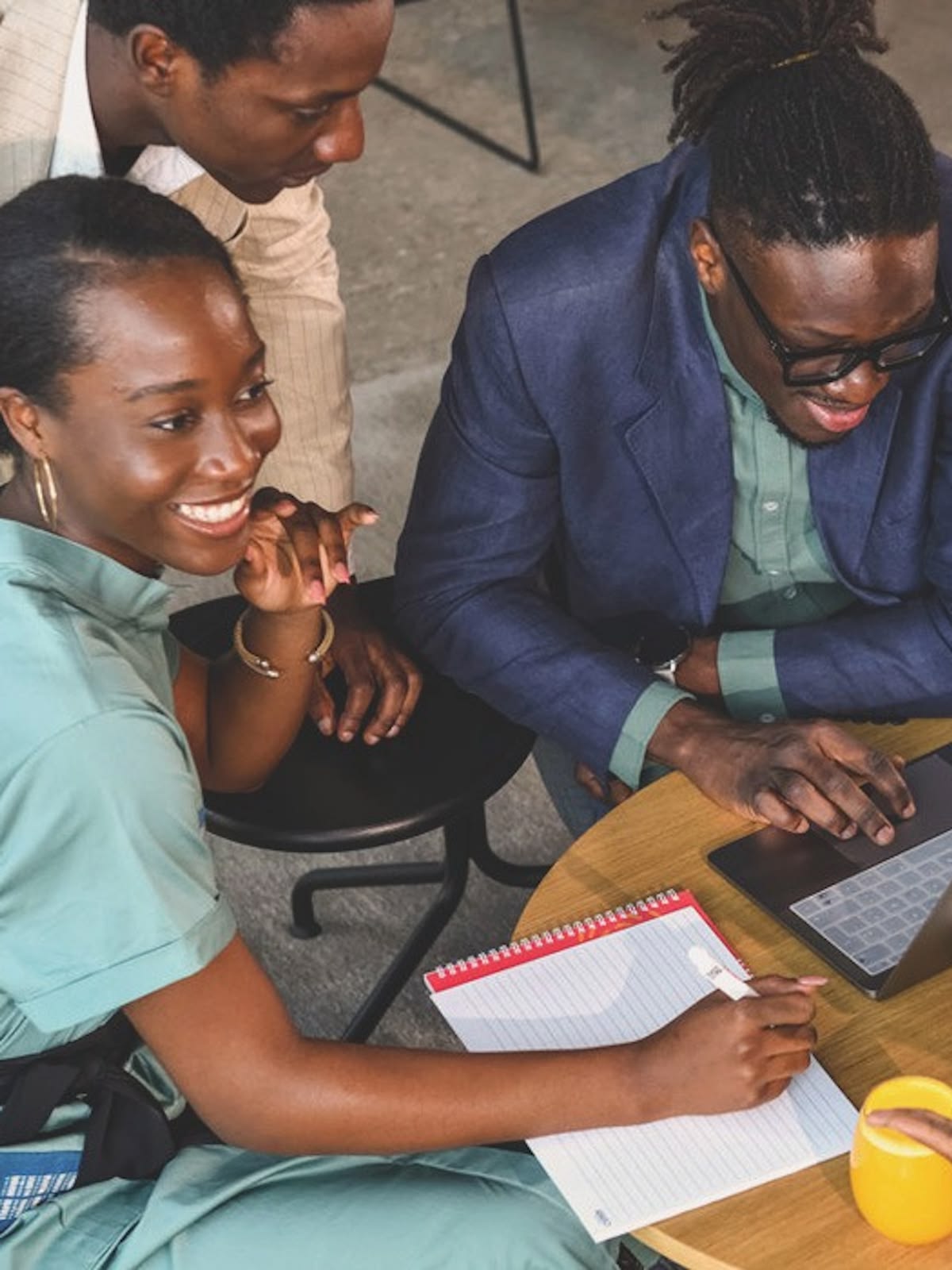 Young professionals working together around a laptop