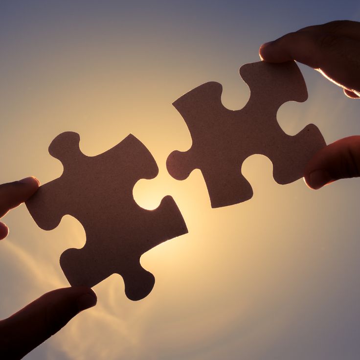 Two puzzle pieces being fitted together
