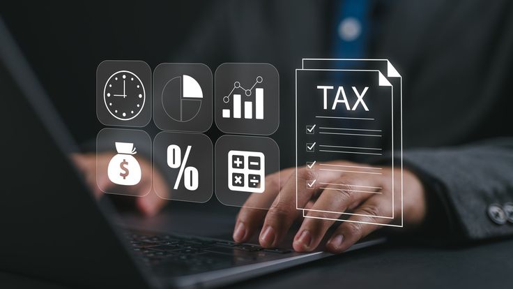 Digital tax and compliance icons over a laptop keyboard